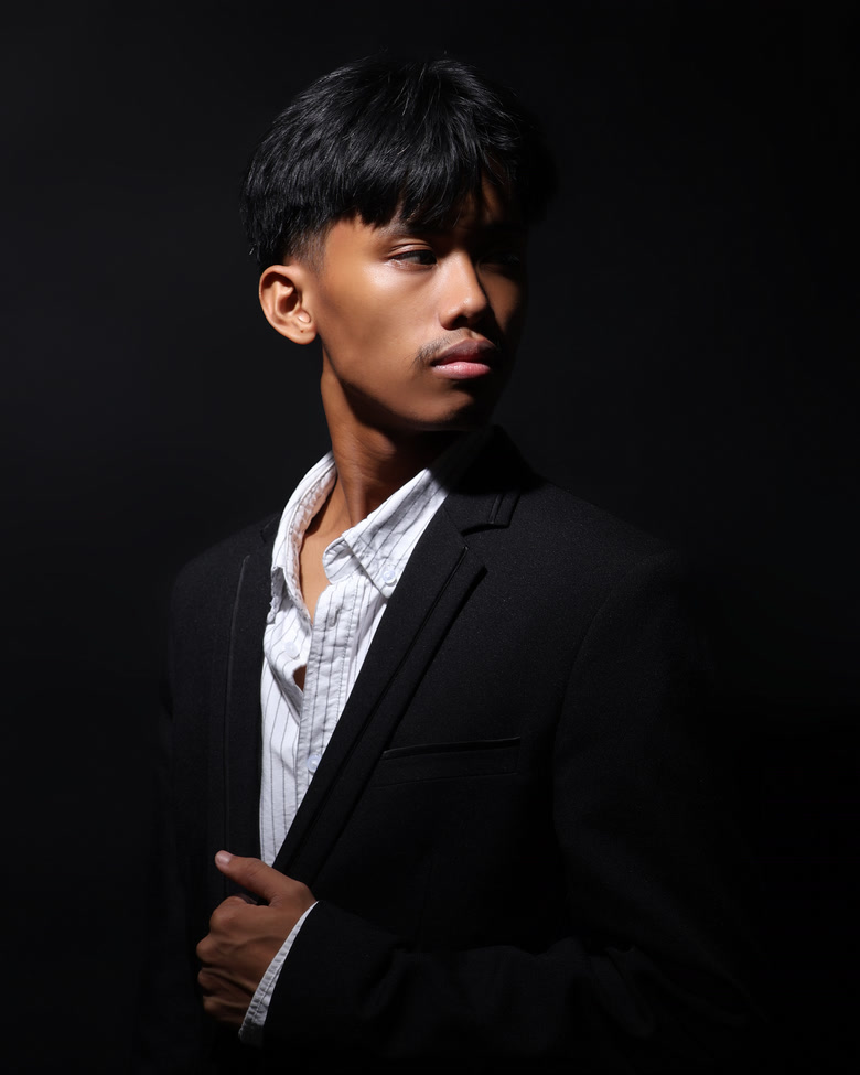 Daniel Rodriguez in a dark professional studio portrait.